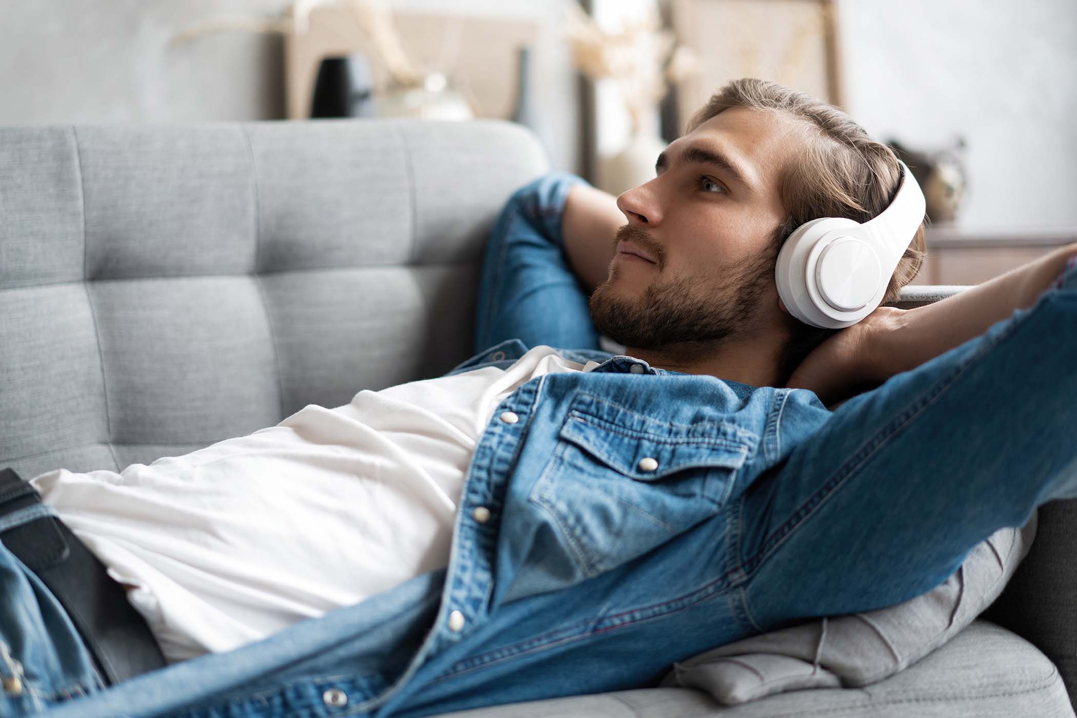 Man relaxing on the couch and listening to music